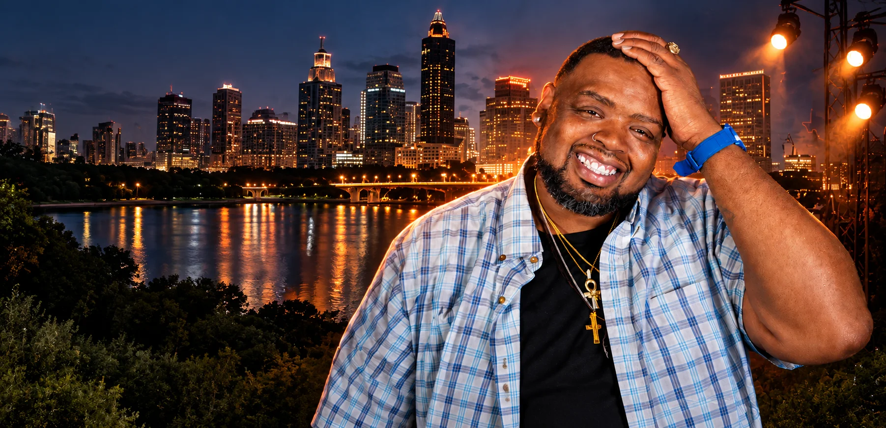Charlie Mac smiling in front of Austin's illuminated nighttime skyline